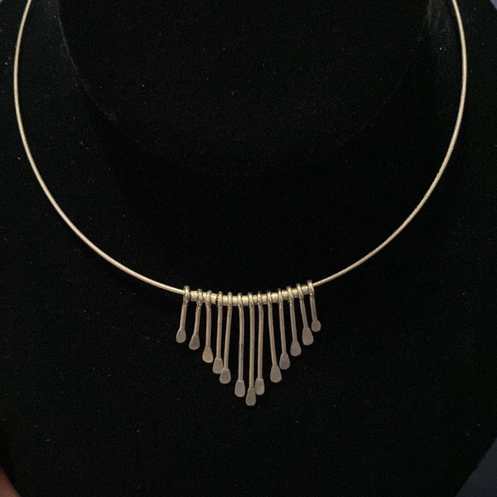 Women’s fashion cuff-style necklace with metal dangles.
